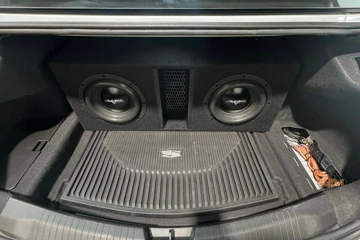 Two subwoofers mounted behind the boot trim of a car finished at Mr. Tint
