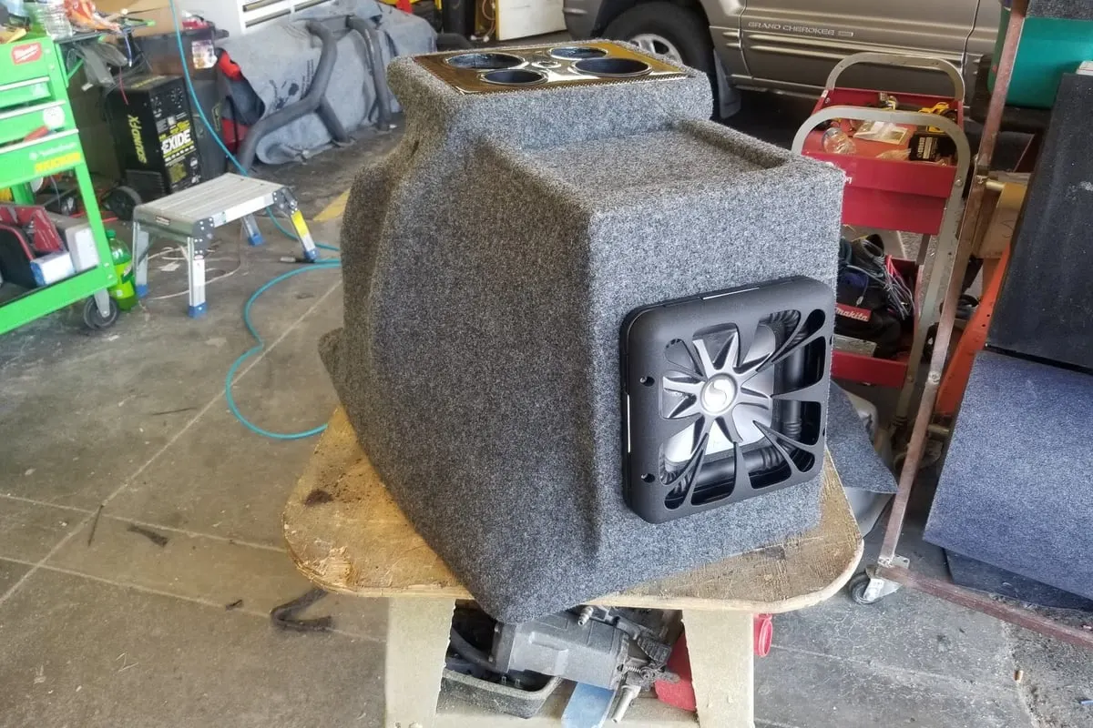 A custom subwoofer enclosure on the bench at the Mr. Tint shop, part-built