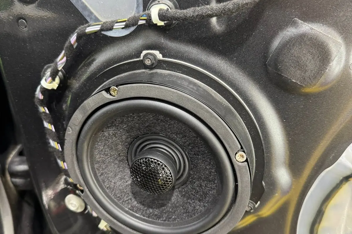 A replacement speaker seated in a vehicle door at Mr. Tint