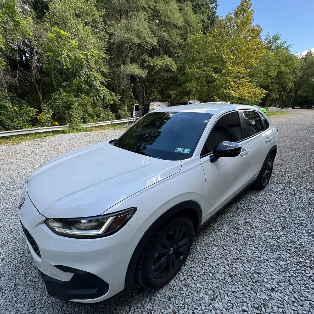 A white Honda SUV with tinted glass on the lot at Mr. Tint