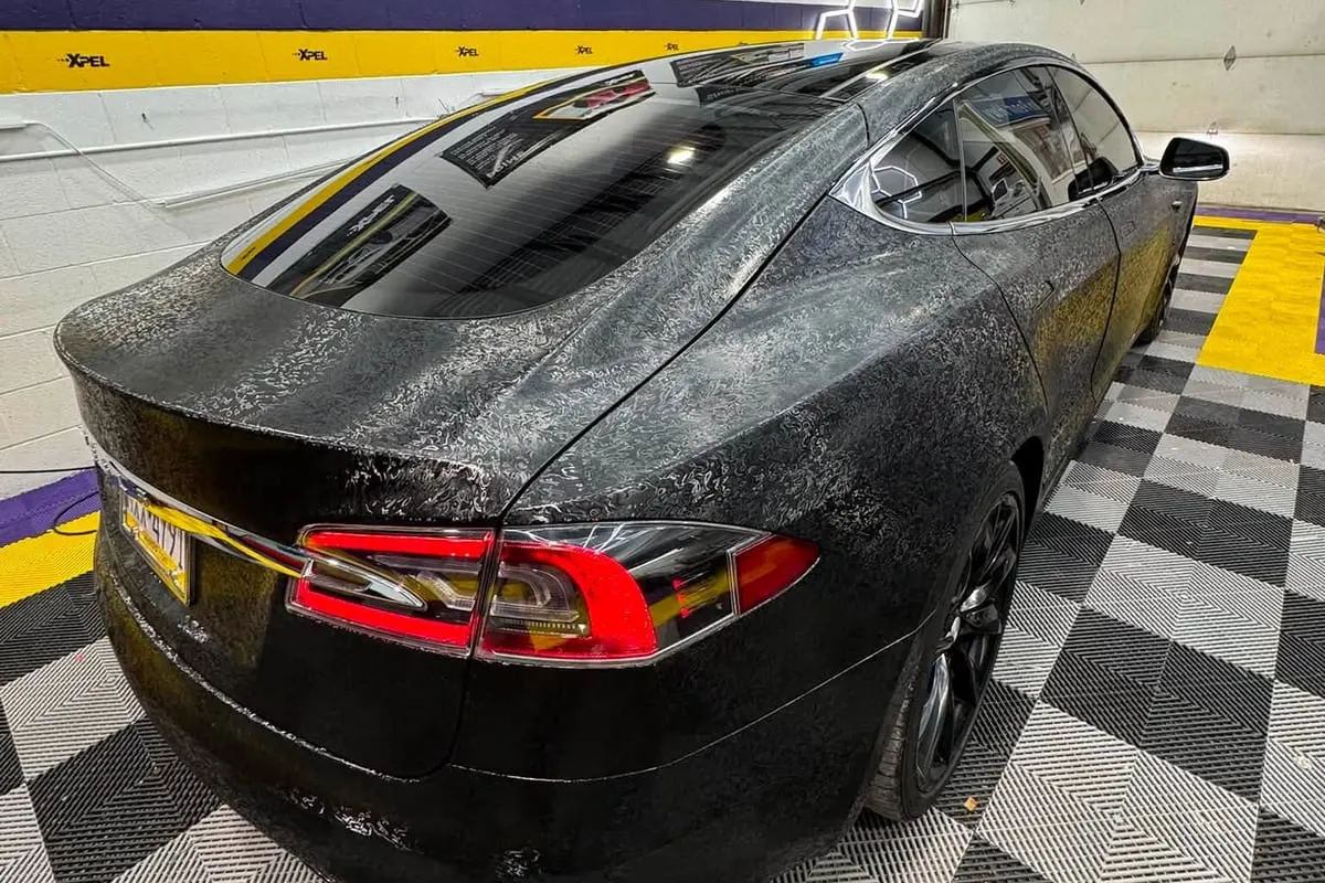 Water beading on the rear bodywork of a ceramic-coated saloon