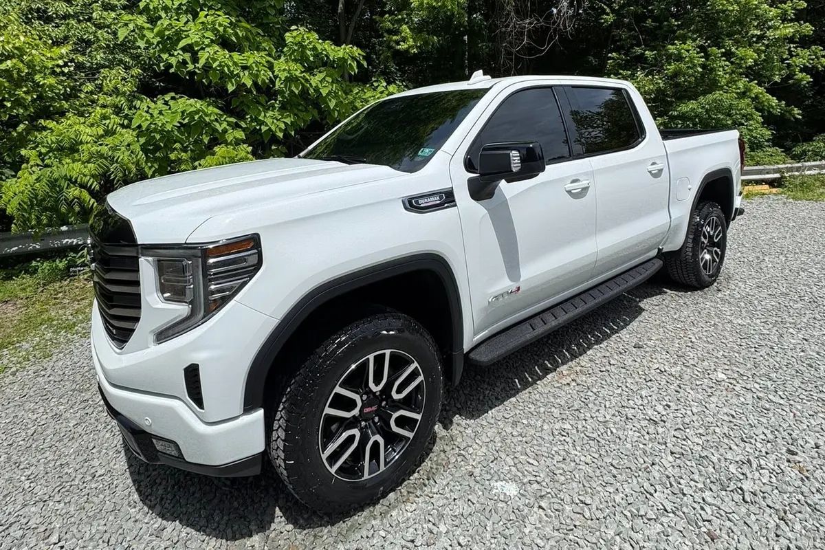 The side of a white GMC Sierra pickup at Mr. Tint after ceramic coating