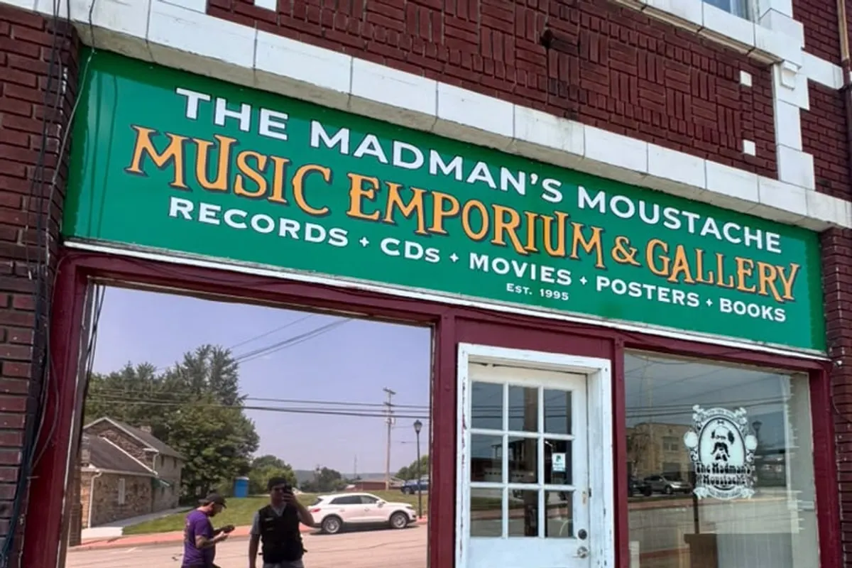 The glazed frontage of a Pittsburgh record shop fitted with window film, its sign above the window