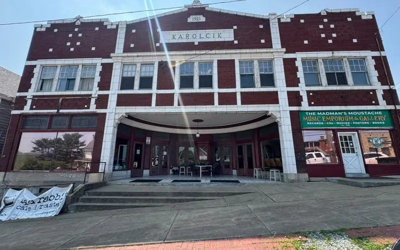 A wide brick commercial building in Pittsburgh with filmed glazing along its frontage