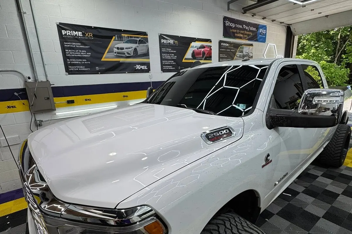 A white Ram 3500 pickup in the Mr. Tint bay after ceramic window tint