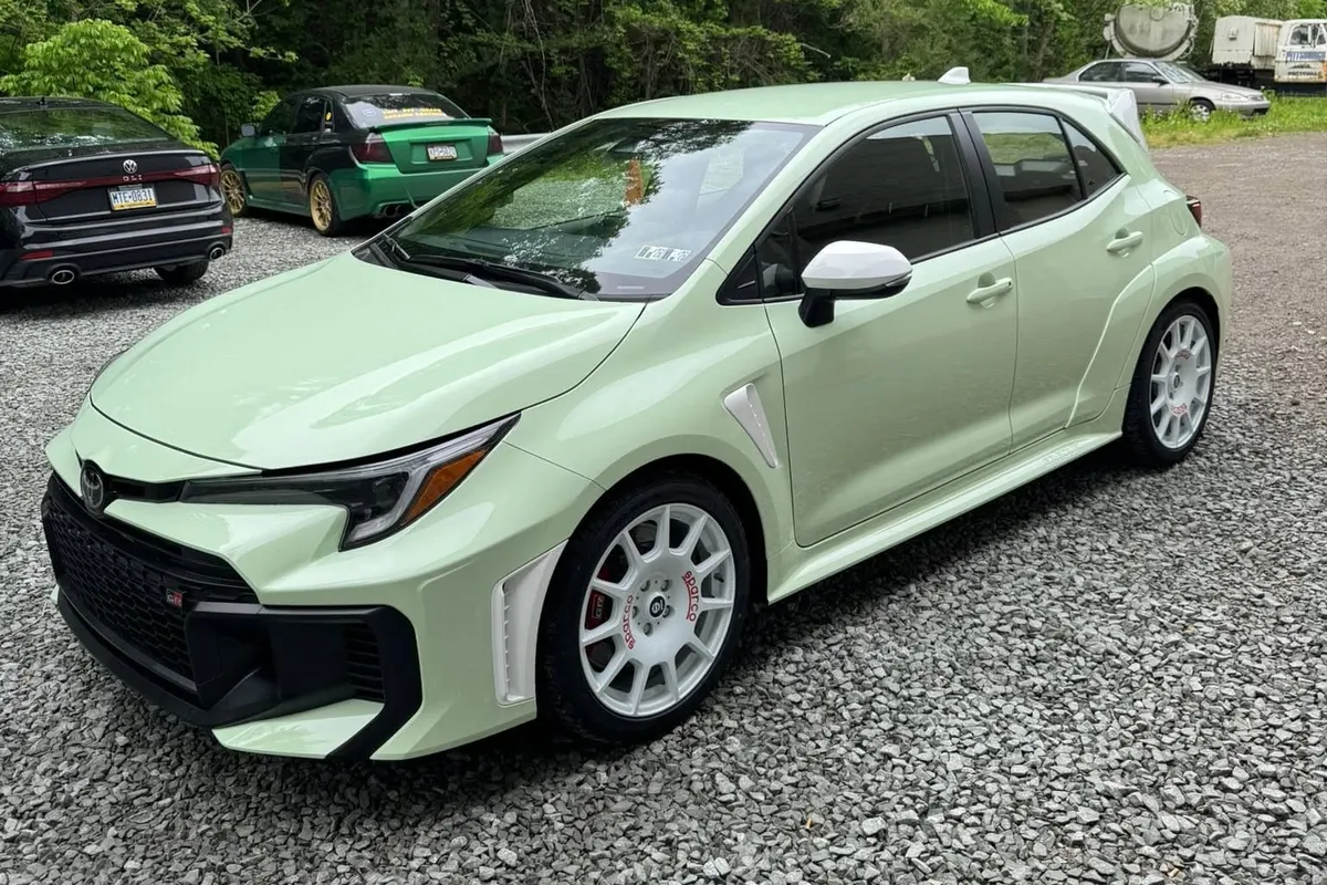 A mint green Toyota GR Corolla on the gravel at Mr. Tint after ceramic coating
