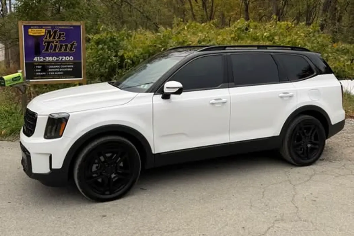 A white Kia Telluride outside the Mr. Tint shop sign in Plum, Pennsylvania, after ceramic coating