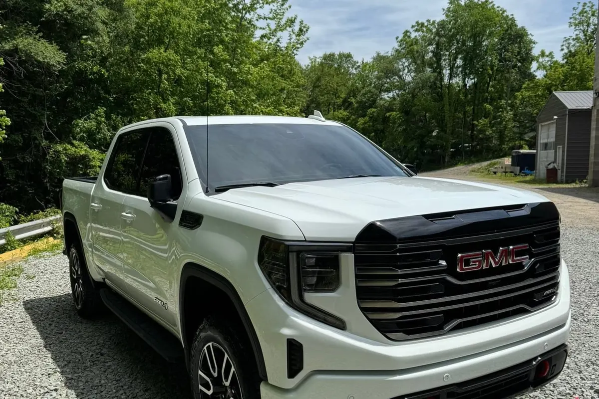 A white GMC Sierra pickup seen from the front corner at Mr. Tint after ceramic coating
