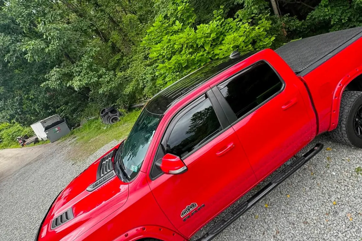 A red wrapped pickup truck on the gravel at Mr. Tint