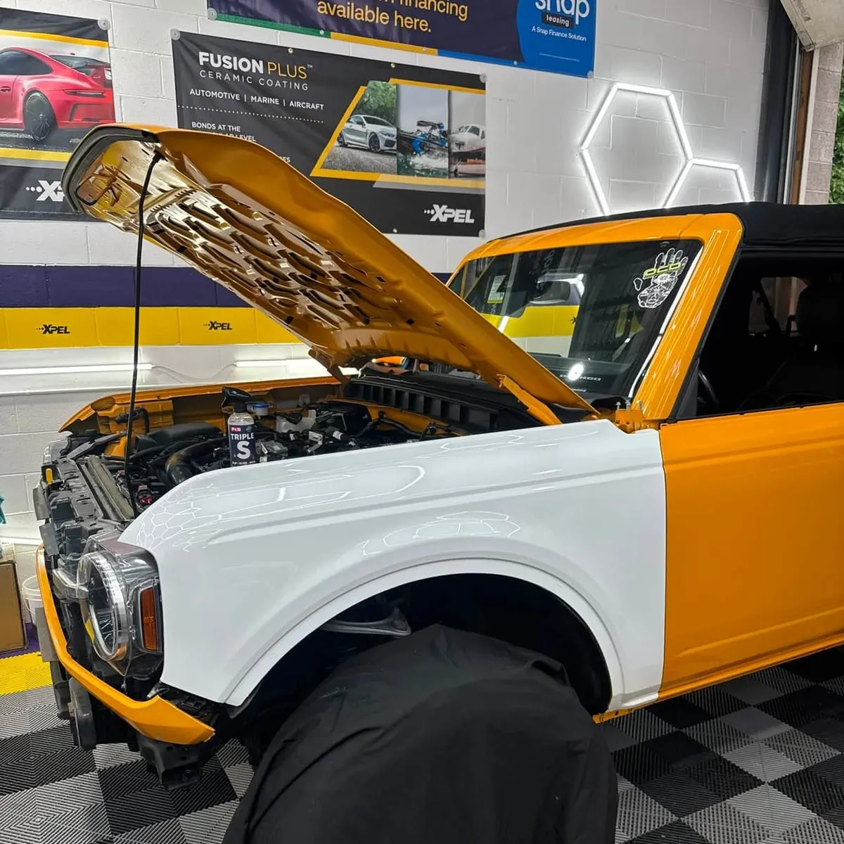 A Ford Bronco with the bonnet raised during a paint protection film fitting at Mr. Tint