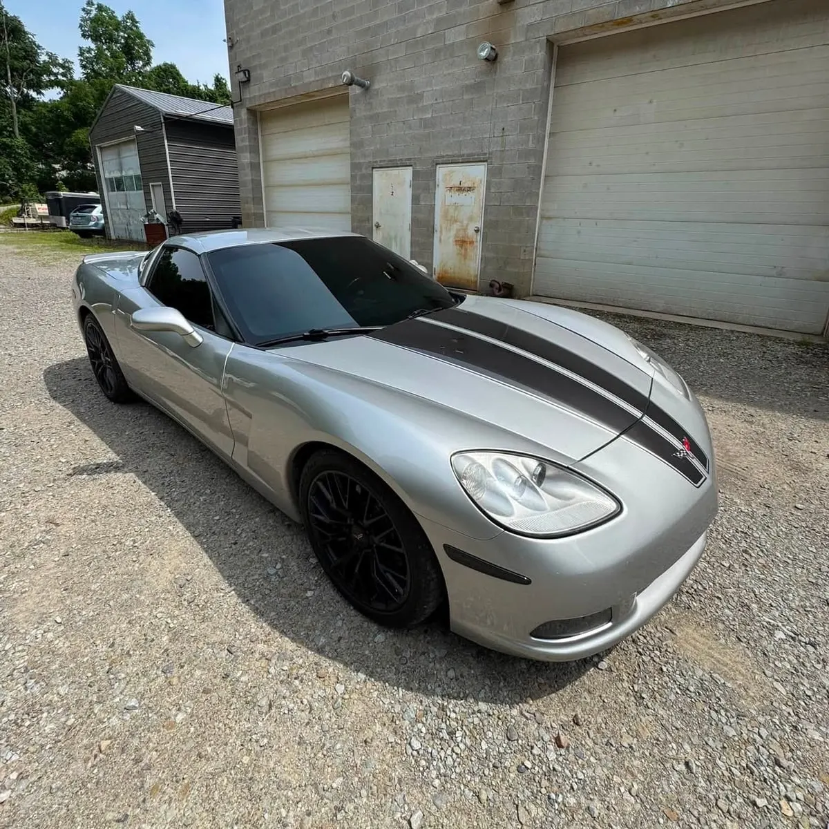 A silver Chevrolet Corvette with ceramic window tint at Mr. Tint in Plum, Pennsylvania