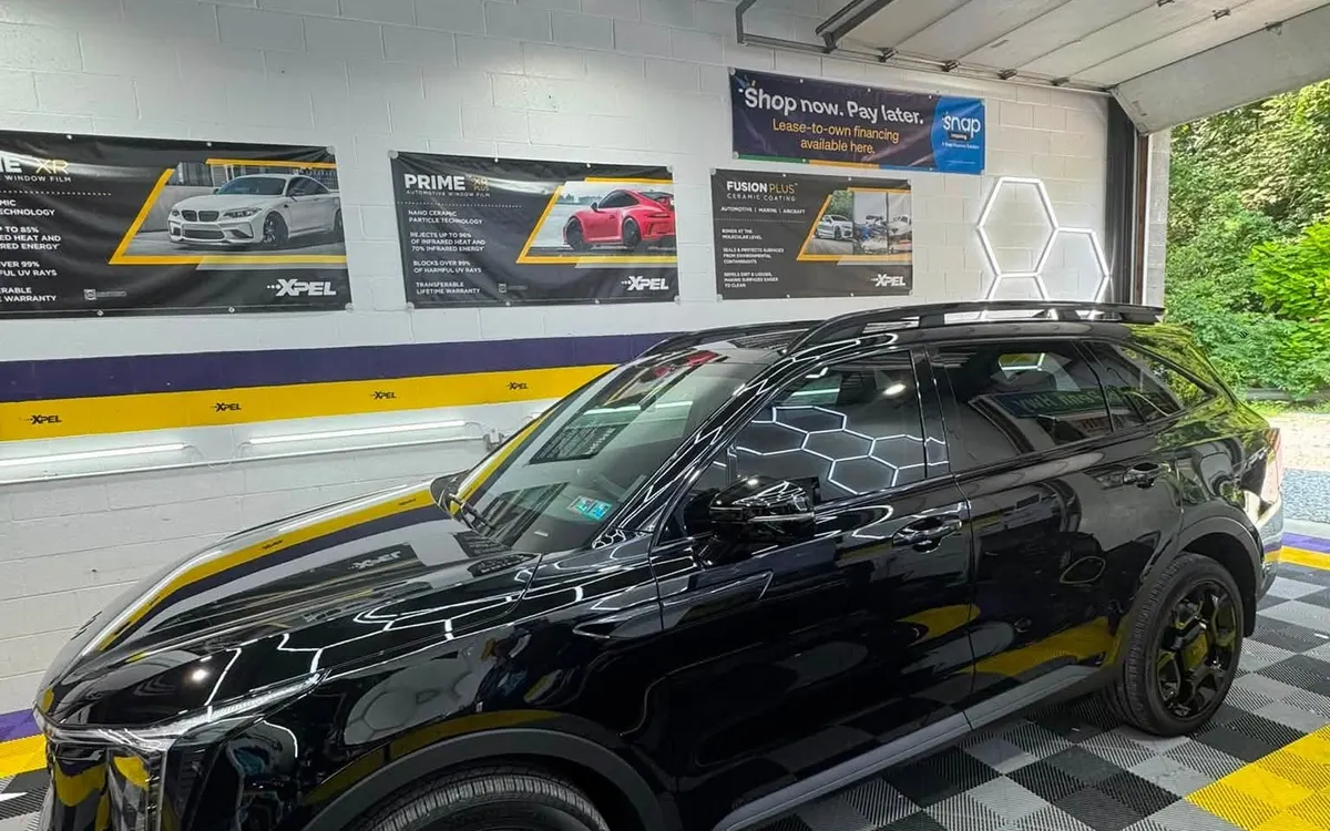 A dark SUV inside the Mr. Tint installation bay in Plum, Pennsylvania
