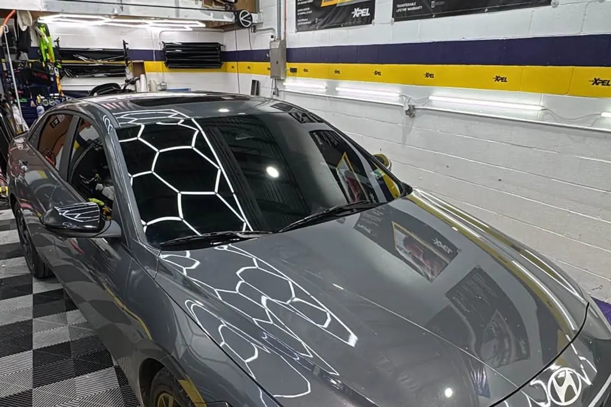 A grey saloon inside the Mr. Tint installation bay
