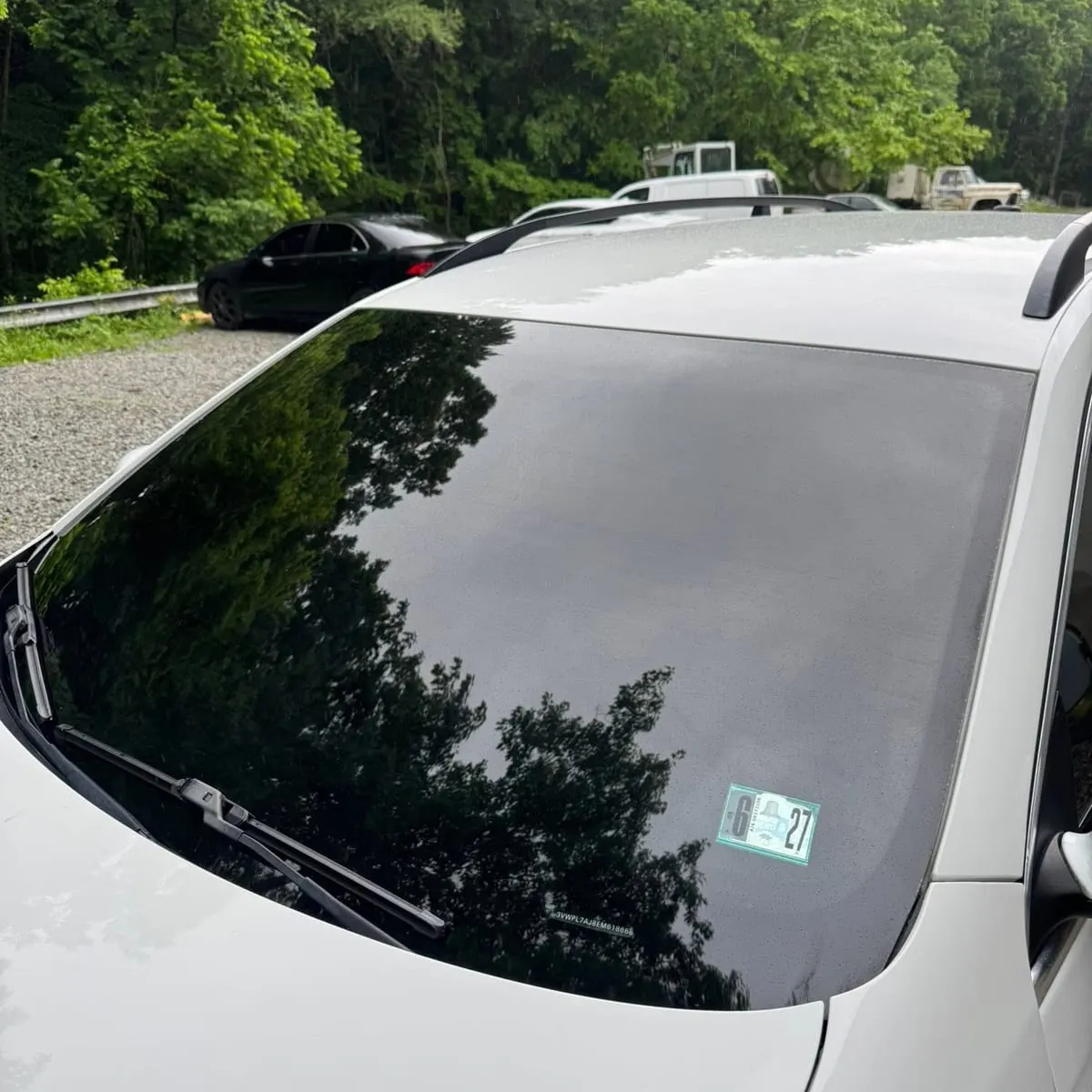 Dark window film across the windscreen and roof glass of a car finished at Mr. Tint