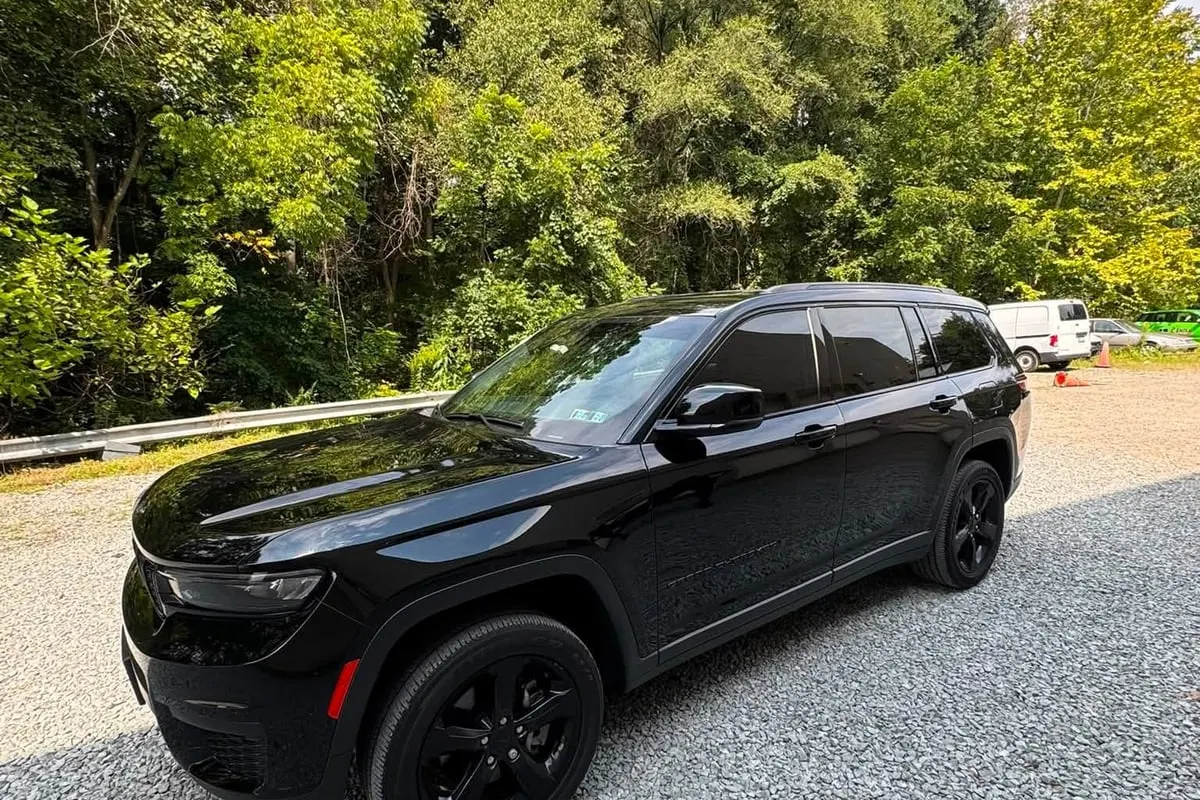 A black Jeep Grand Cherokee with tinted windows at Mr. Tint