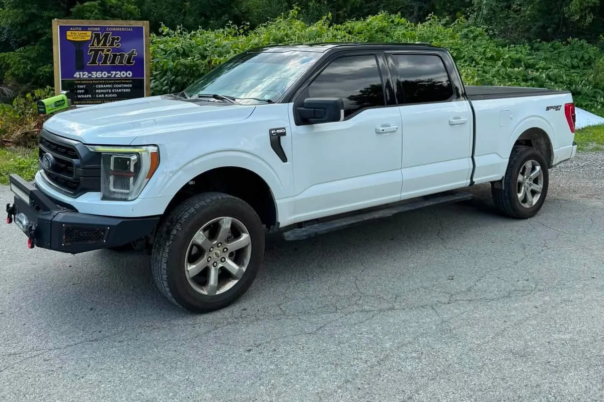 A white pickup with vinyl accents outside the Mr. Tint shop in Plum, Pennsylvania
