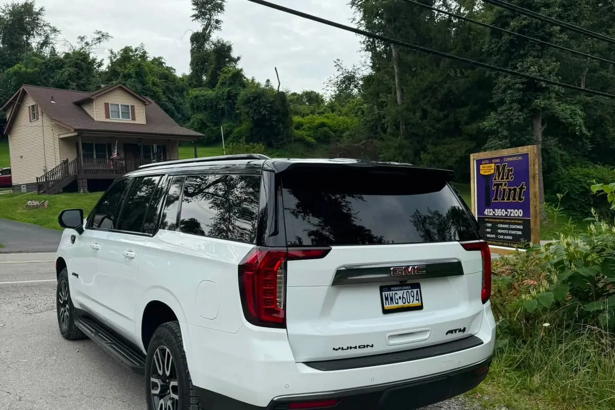 The rear of a white GMC Yukon wrapped at Mr. Tint
